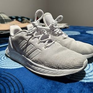 White Adidas sports shoes.